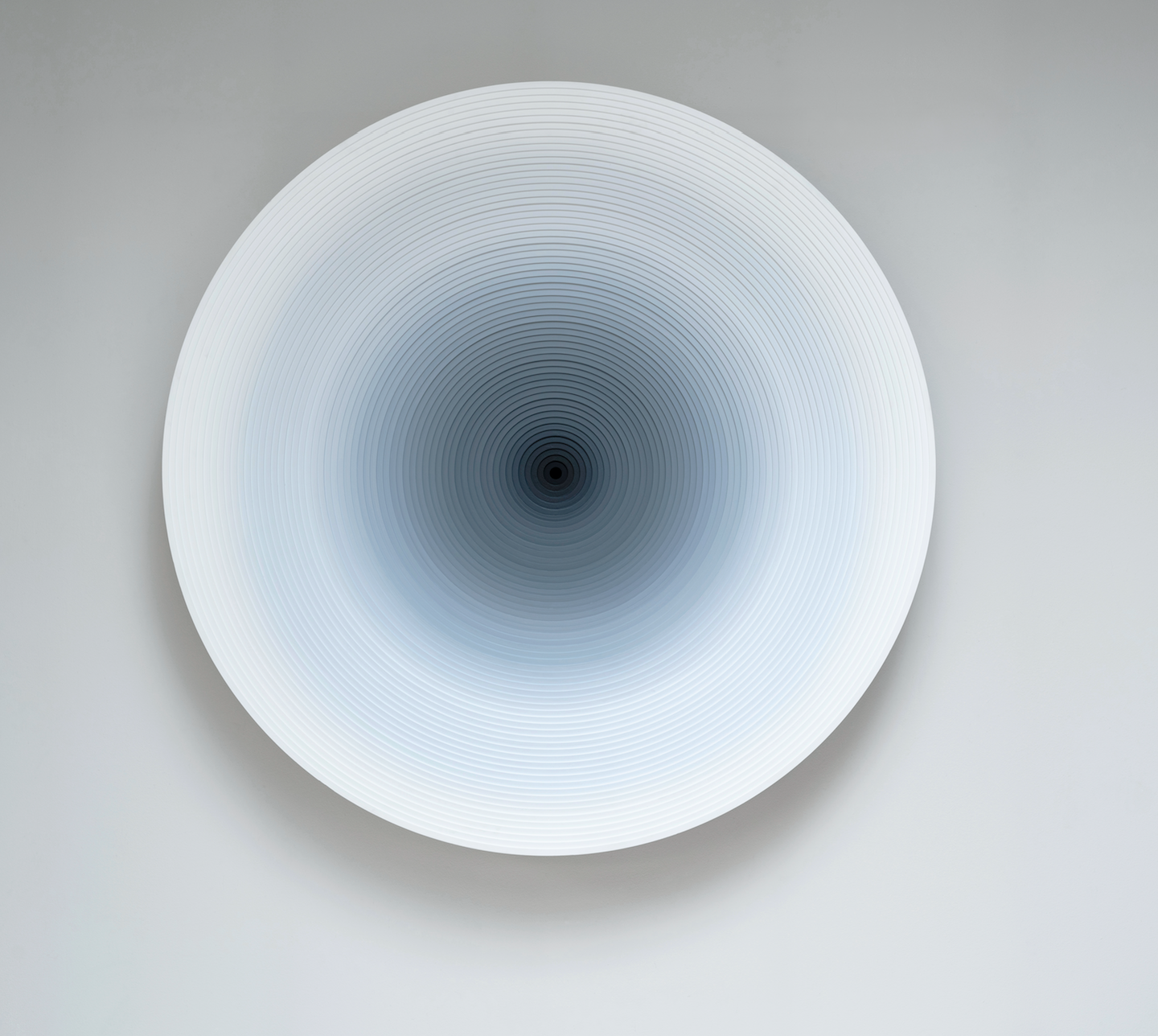 White concentric relief darkening toward its centre