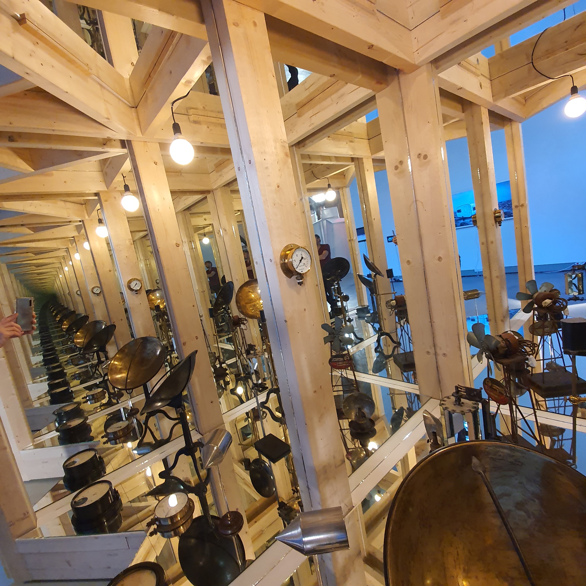 Timber and mirrors repeat into the distance