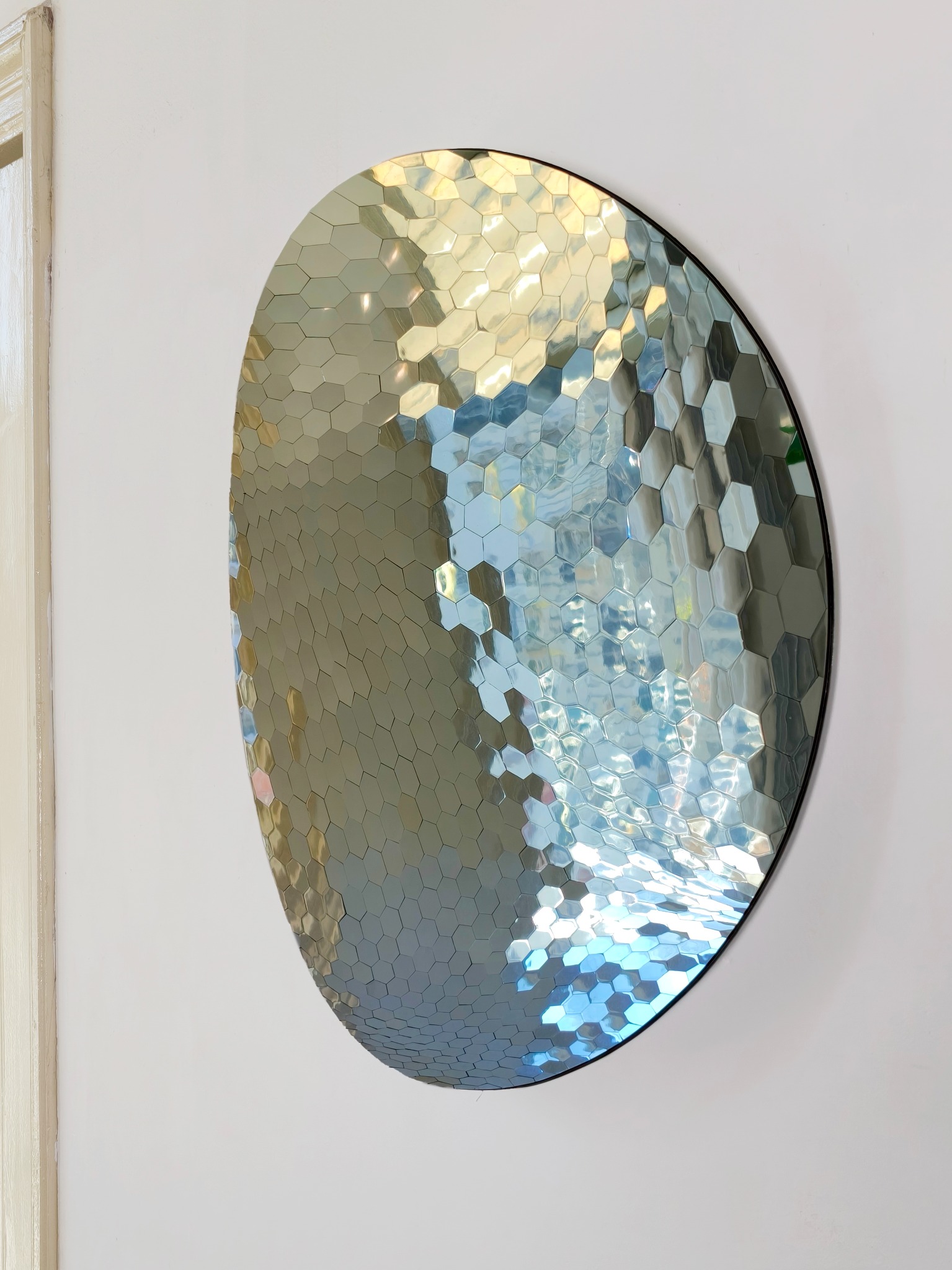 Curved mirror reflecting gold and blue light