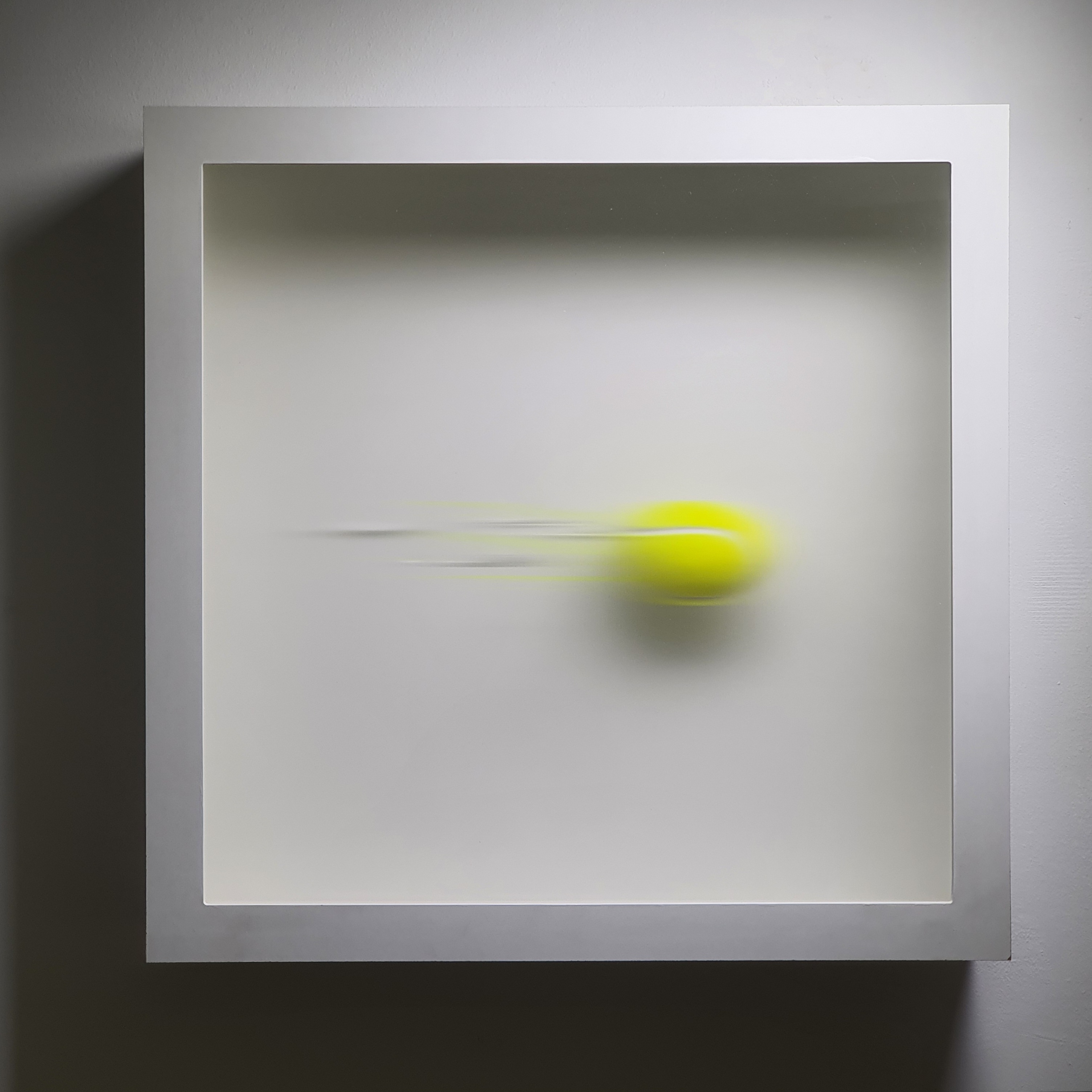 Framed tennis ball in motion