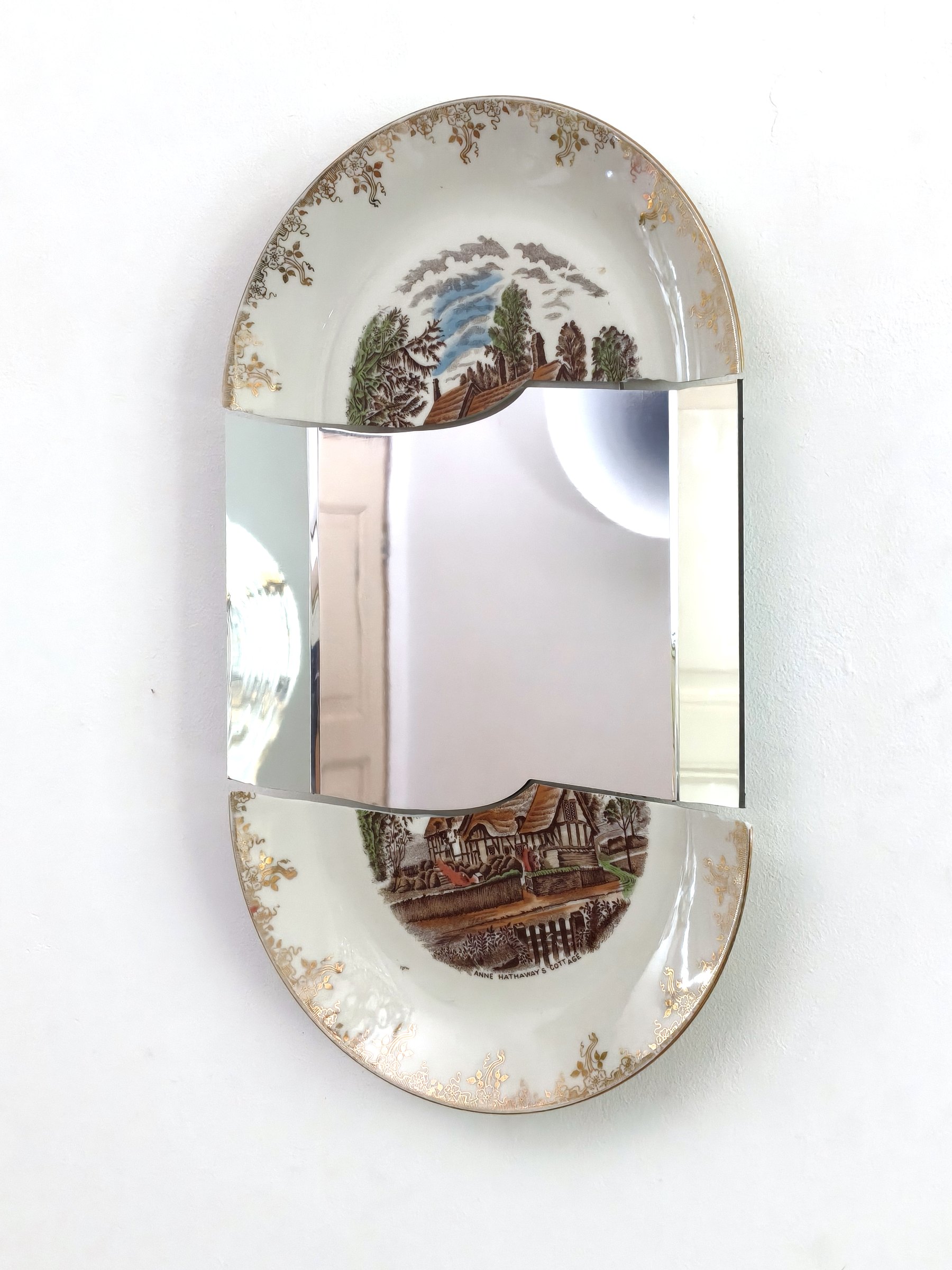 Decorated oval porcelain plate with a central mirror