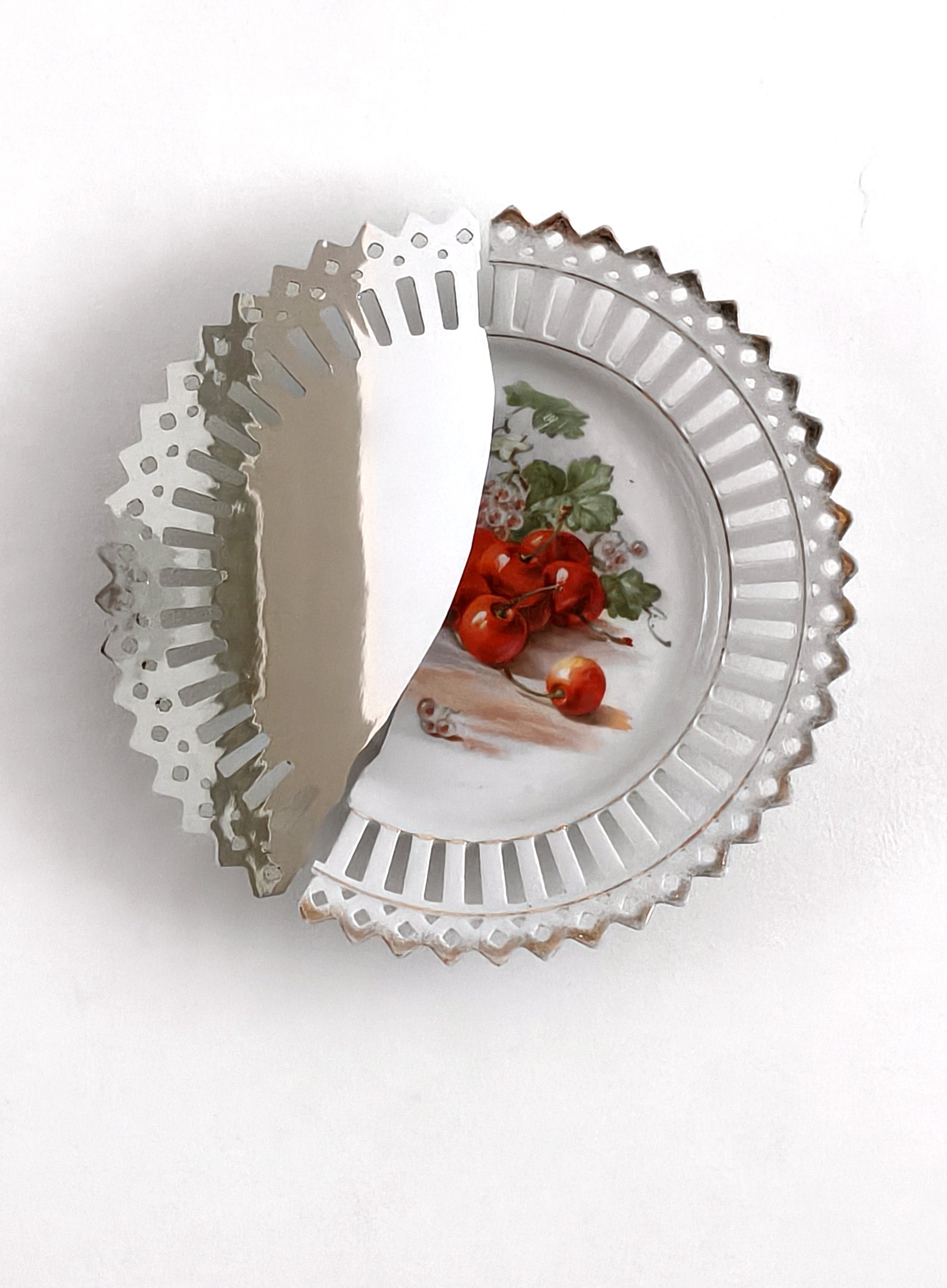 Ornate porcelain plate interrupted by reflection