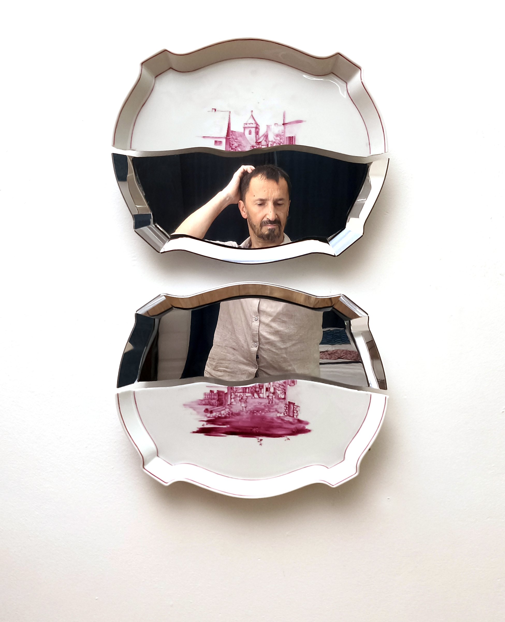 Two porcelain mirror pieces reflecting the viewer